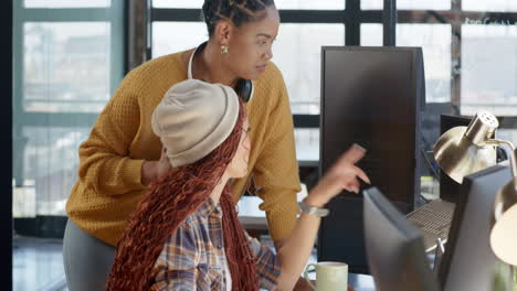 collaborating on coding project, diverse female team using computer and smartphone in office