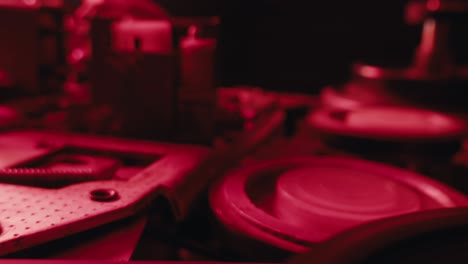 close-up view of vintage machinery parts under red light