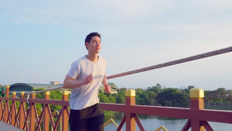 man running on a bridge