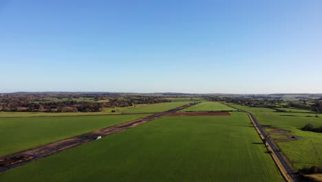 Aerial-shot-of-the-old-airstrip-of-RAF-Upottery-at-smeatharpe-Devon-England-on-a-beautiful-sunny-summers-day