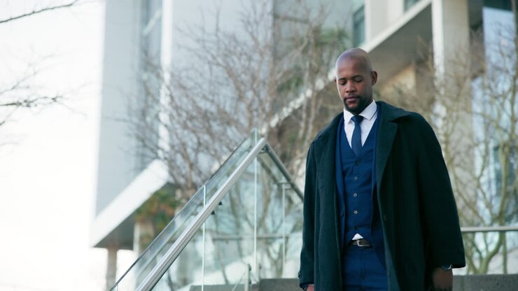 Businessman Walking Down Stairs in a City