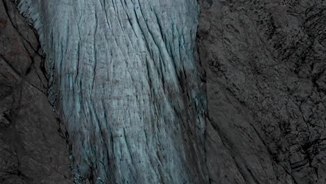 Aerial-view-of-the-Gauli-glacier-in-the-Bernese-Oberland-region-of-the-Swiss-Alps-with-a-panning-view-from-the-glacial-tongue-up-towards-the-mountain-peaks