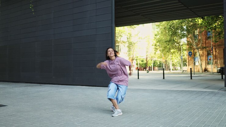 Young Woman Performing Energetic Hip Hop Dance in Urban Setting