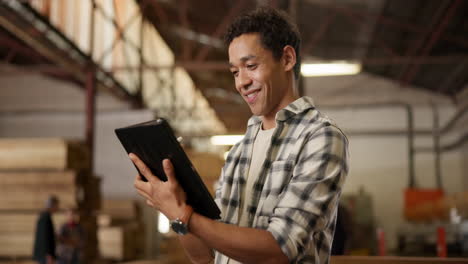 man using tablet in warehouse