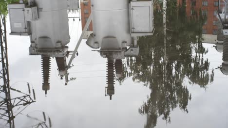 reflection of power station equipment in a puddle