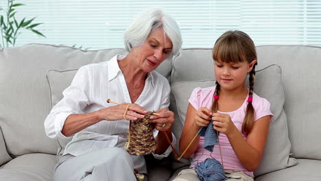 granny teaching her granddaughter how to knit