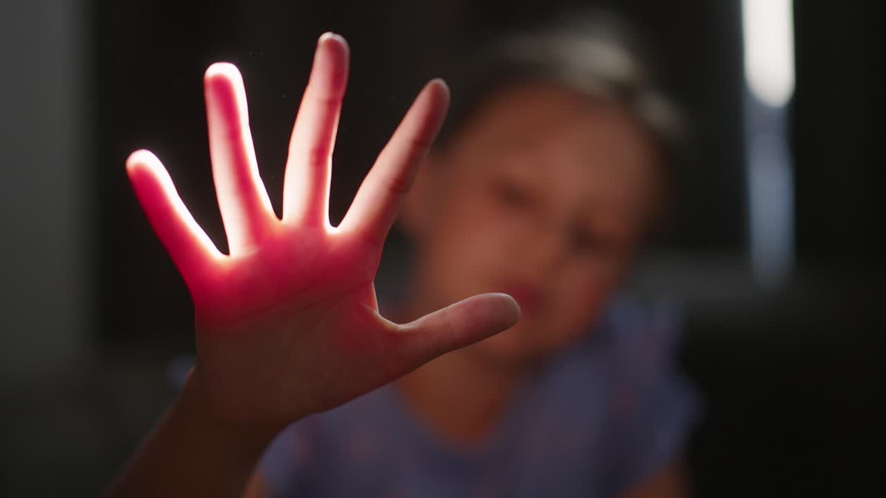 Child's Hand Playing with Sunlight and Dust Particles