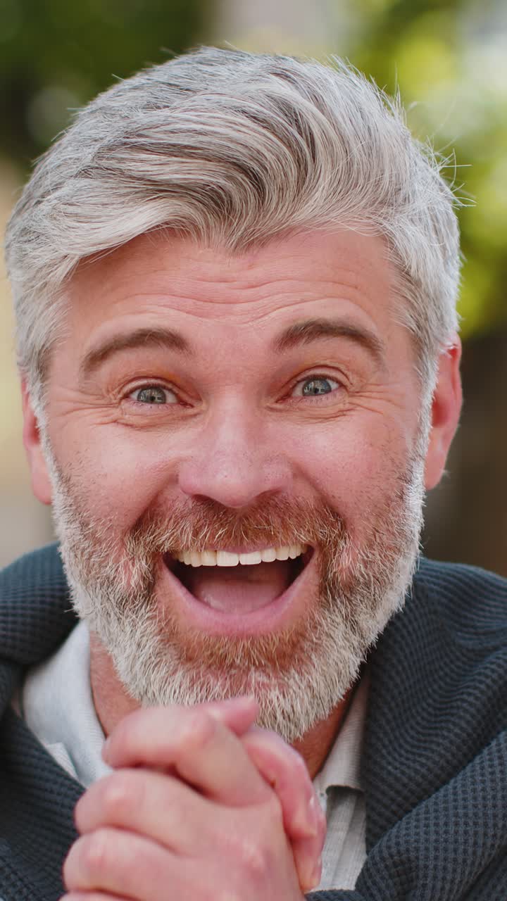 Excited amazed mature man looking surprised at camera with big open eyes shocked by sudden victory