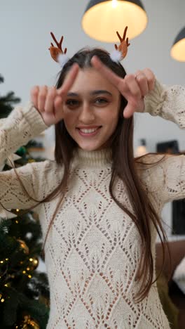 mujer sonriendo frente a un árbol de navidad