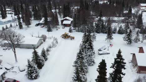 drone video captures the power and a snow plow in action as it clears snow in the winter wonderland of alaska