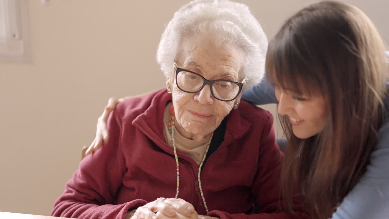 Granddaughter cheers up her sad grandmother in a nursing home