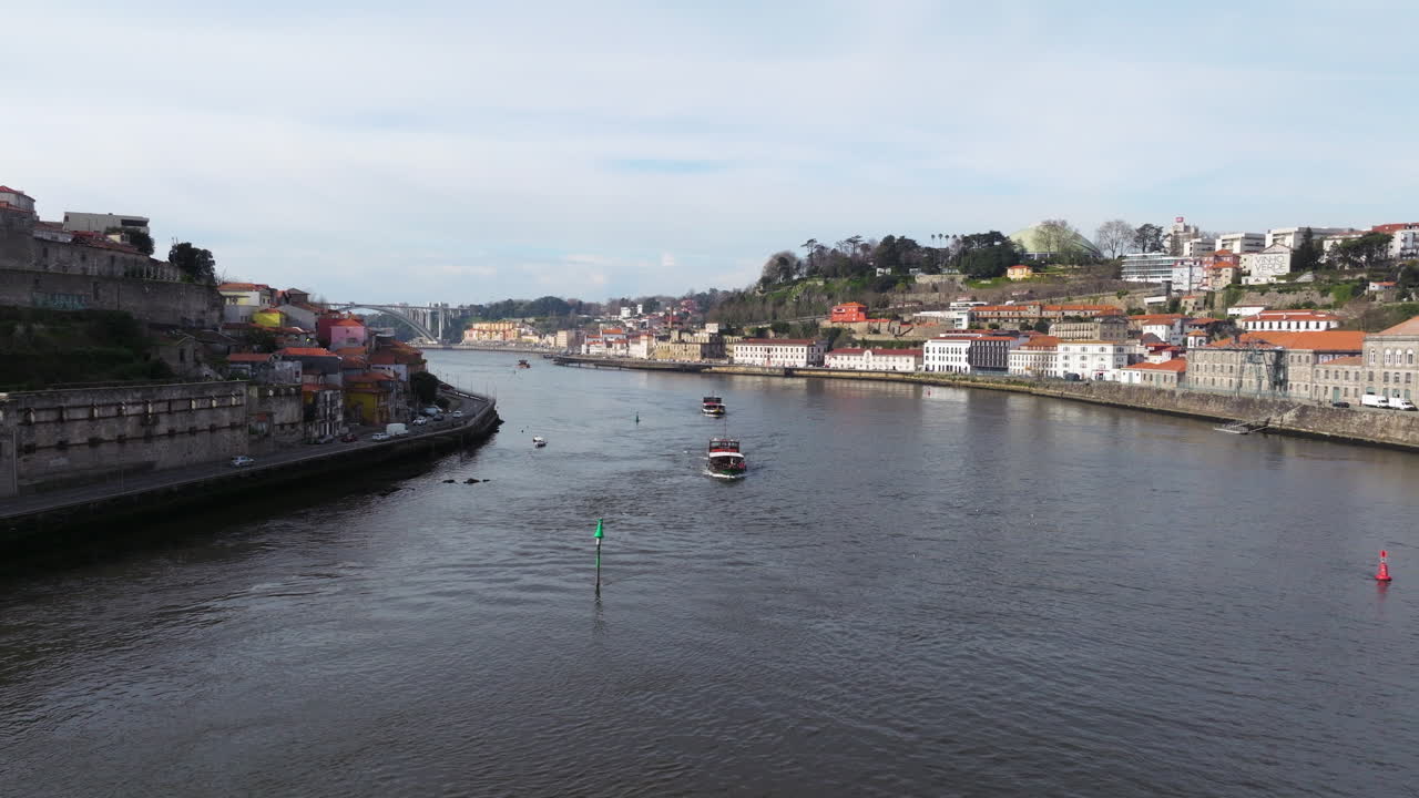 Colorful houses and tiled roofs in strong light