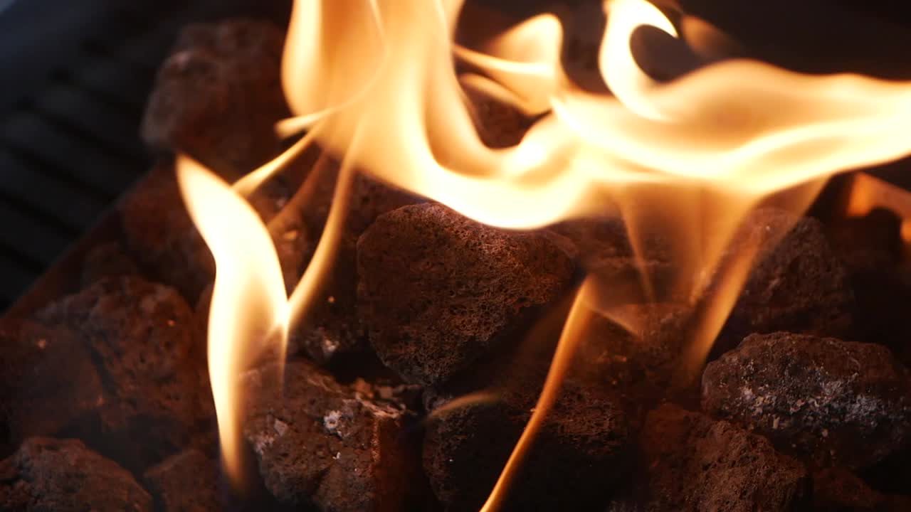 Vibrant Flames Dancing Over Dark Rocks