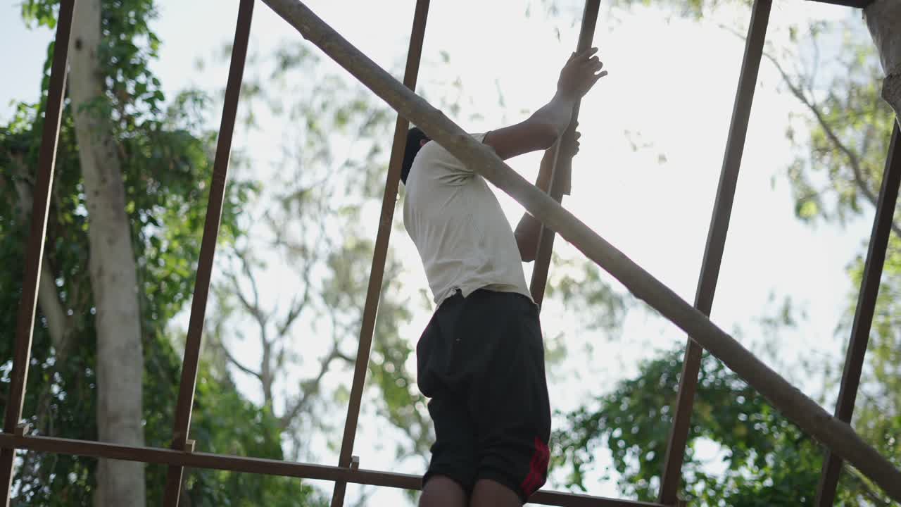 Man working on scaffolding or metal structure outdoors