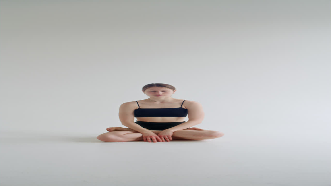 Girl Meditating in Lotus Pose with Hands in Prayer during Yoga Practice