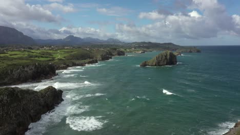 aerial forward over playa de poo coast in asturias, spain