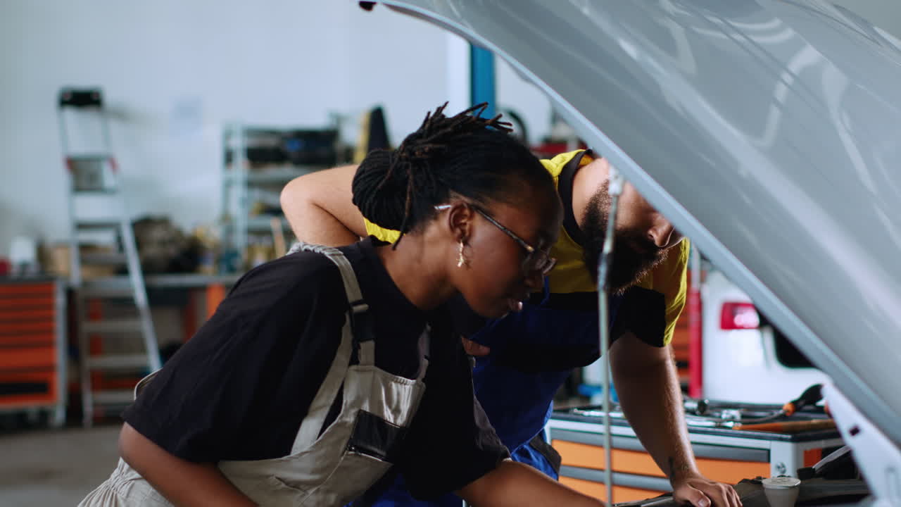 Coworking technicians fixing car