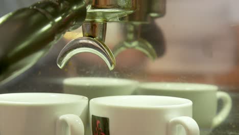 how-to-make-a-real-Italian-espresso:-closeup-footage-of-coffee-dripping-into-two-espresso-cups-at-a-coffee-bar