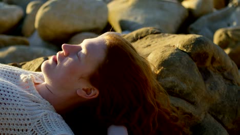 woman relaxing on the beach at dusk 4k