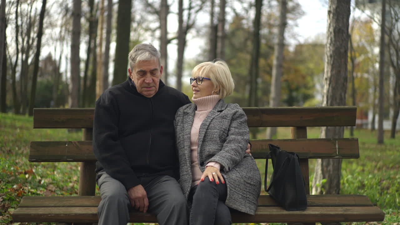 Senior Couple Sitting on Park Bench