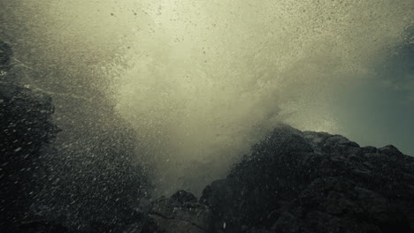 powerful waves crashing against rocks