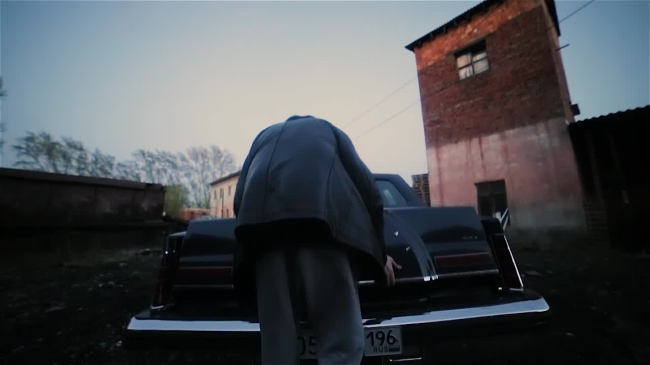 Man loading car trunk at night