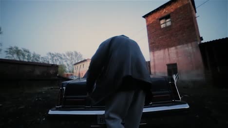 Man loading car trunk at night