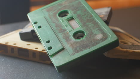 a stack of four audio cassettes on a table