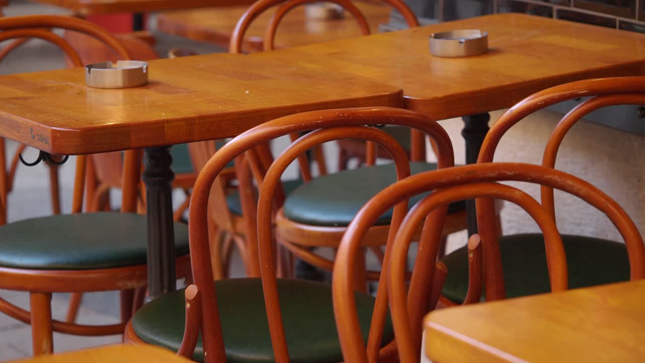 Empty Wooden Tables and Chairs in an Outdoor Cafe