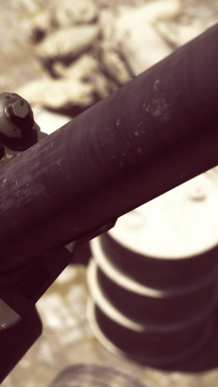 Details of a weapon in an urban setting with industrial background