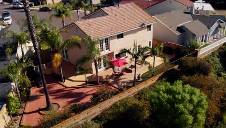 Aerial-rotation-over-a-suburban-home-backyard-on-a-hill