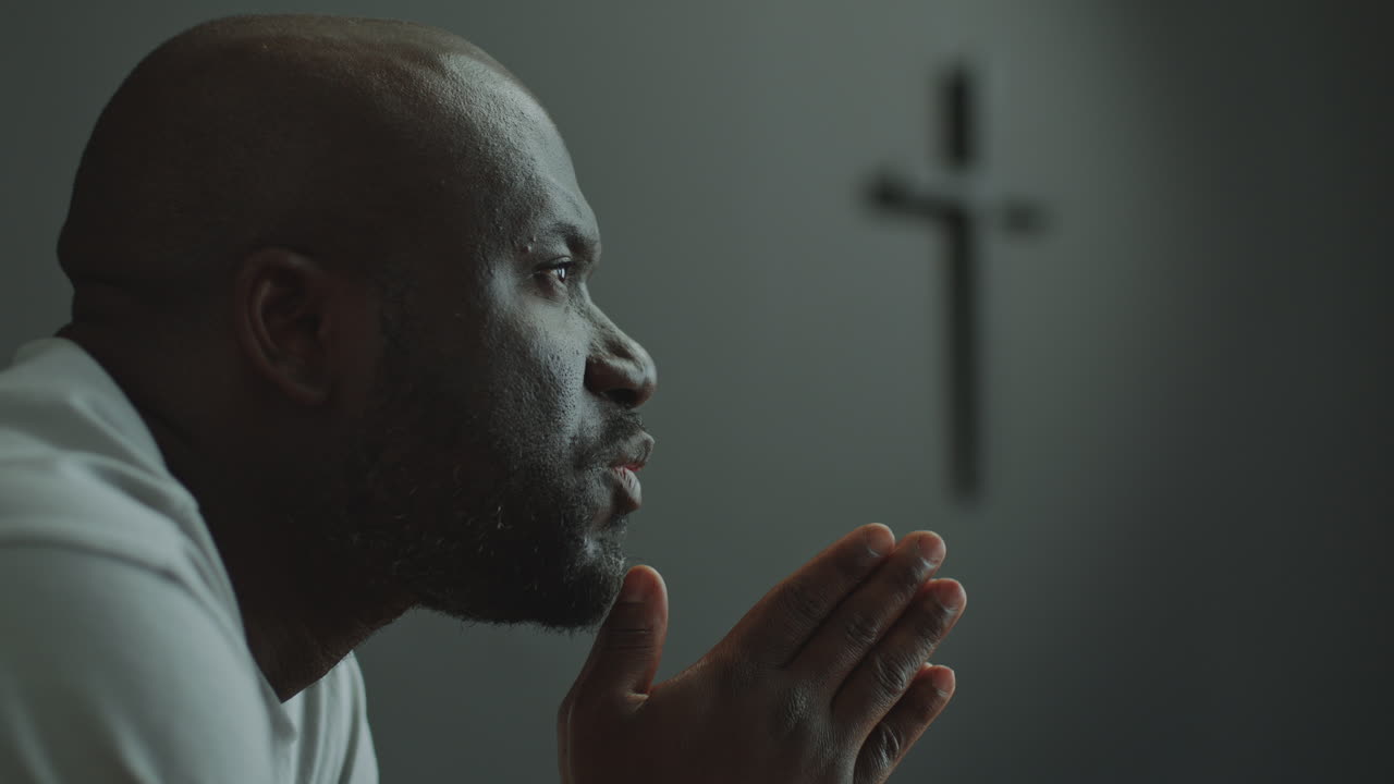 Faithful Man Holding Hands Together and Praying in Church