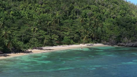 telephoto aerial of hidden sand beach in remote countryside dominican republic