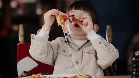 little boy eating delicious pizza