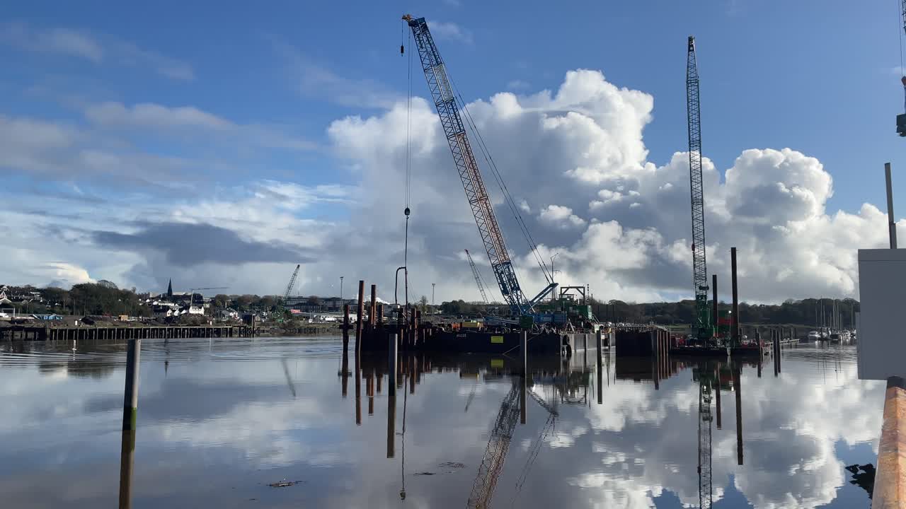 construction barge in the River Suir pile driving for new footbridge across the River Suir Waterford Ireland on a calm winter morning at full tide