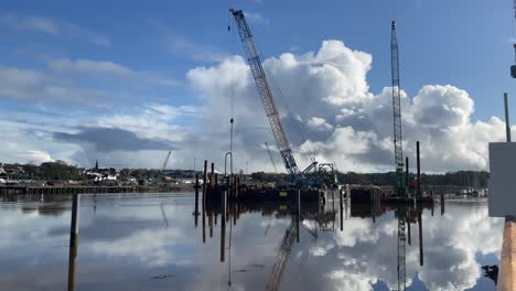 construction barge in the river suir pile driving for new footbridge across the river suir waterford ireland on a calm winter morning at full tide