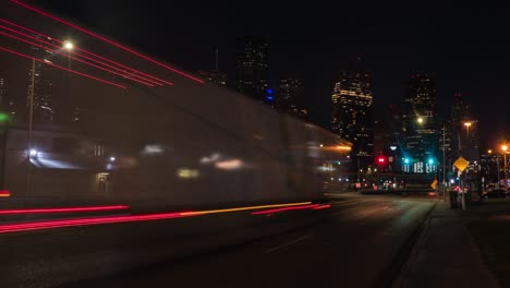 time lapse of cars at night in houston wit downtown in the foreground