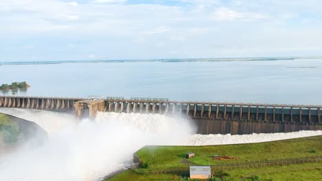 Reservoir-overflowing-flooding-river-downstreem,-Vaaldam-Floods-South-Africa,-Drone-Shot