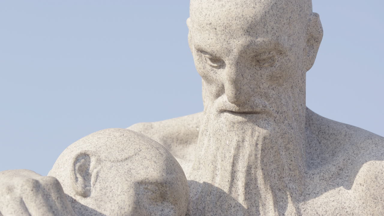 Tilt up of a man looking down at his partner, The Monolith at the Vigeland Park