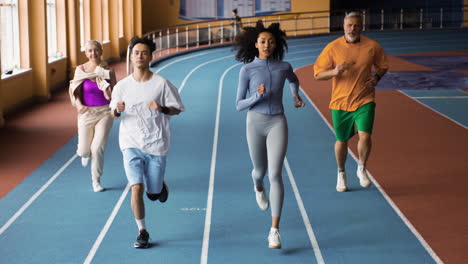 people running in an indoors track