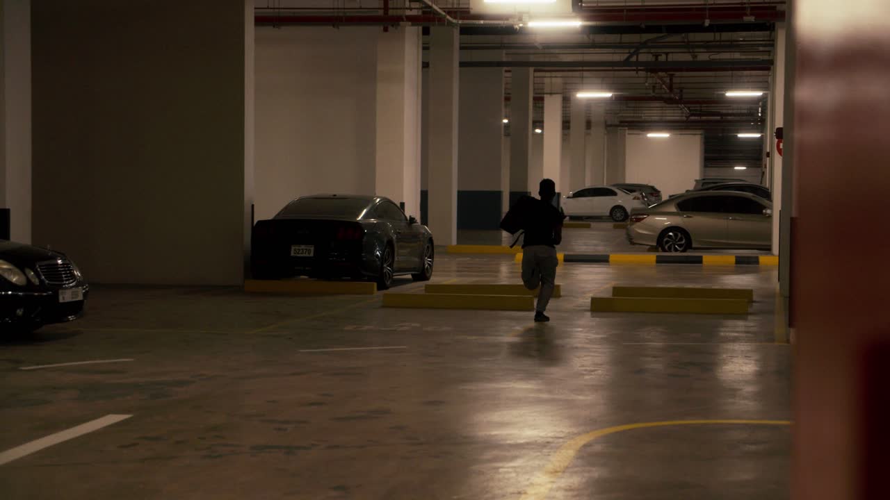 African man running away with handbag stolen from a man