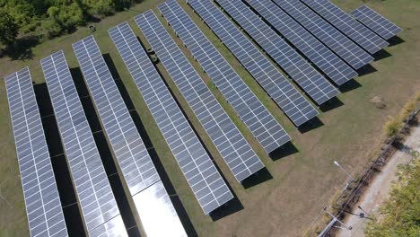 aerial shot above solar panels farm field of green renewable energy