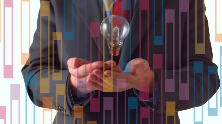 Animation of colourful geometric pattern over businessman throwing and catching lightbulb