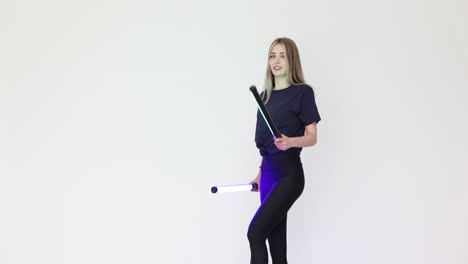 woman posing with colorful led light tubes in a studio