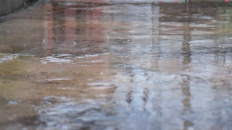 Slow motion of rain drops hitting the ground