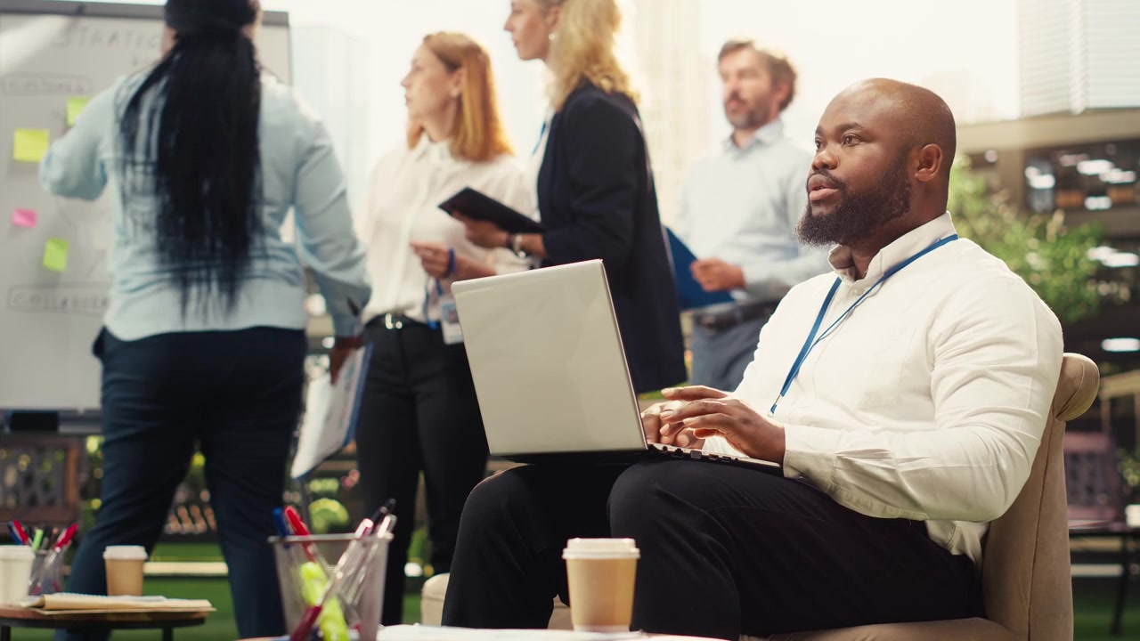 African American Businessman Working on Laptop in Modern Office