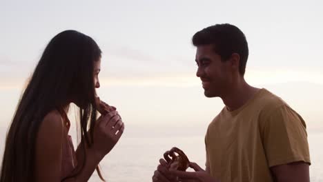 young couple eating together from food truck