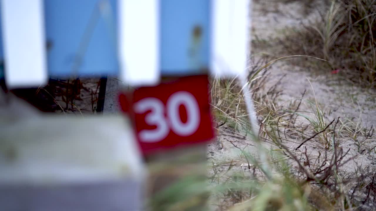 Door sign number 30 getting into focus at a house at the danish beach, slow motion