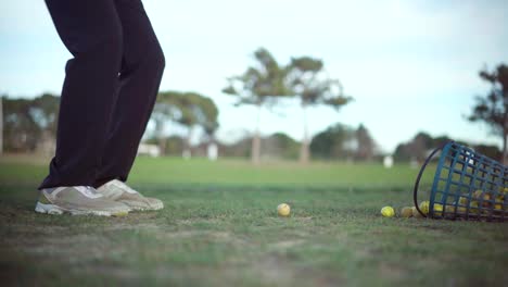 golfer practicing on the fairway on a sunny day, swing shot view from the side