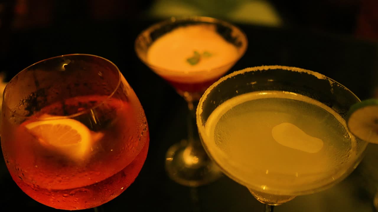 Colorful cocktails on a dimly lit table